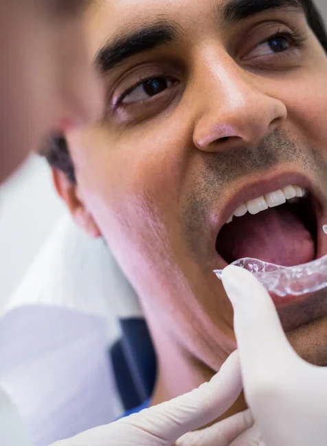dentist-assisting-patient-wear-invisible-braces